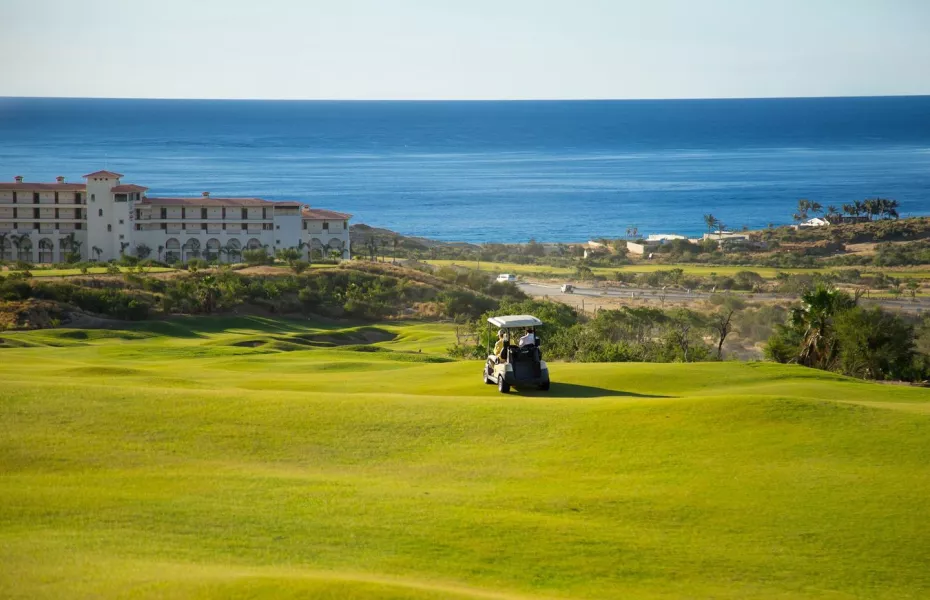 Golf cart on Los Cabos golf course at sunset